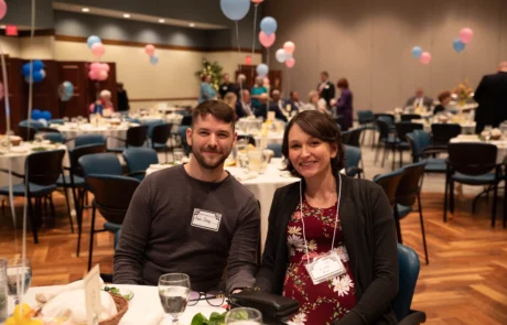 2V9A0002 Smiling couple sitting at table.