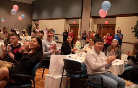 2V9A0154 Applauding, happy families seated in auditorium.