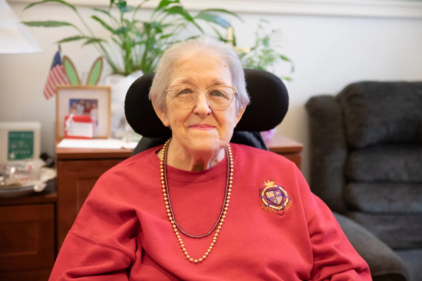 Close up of smiling elderly woman inside her apartment.