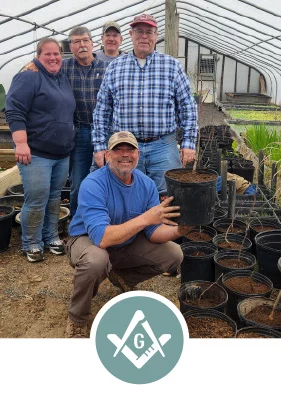 Photo of men in garden nursery with Square and Compass logo