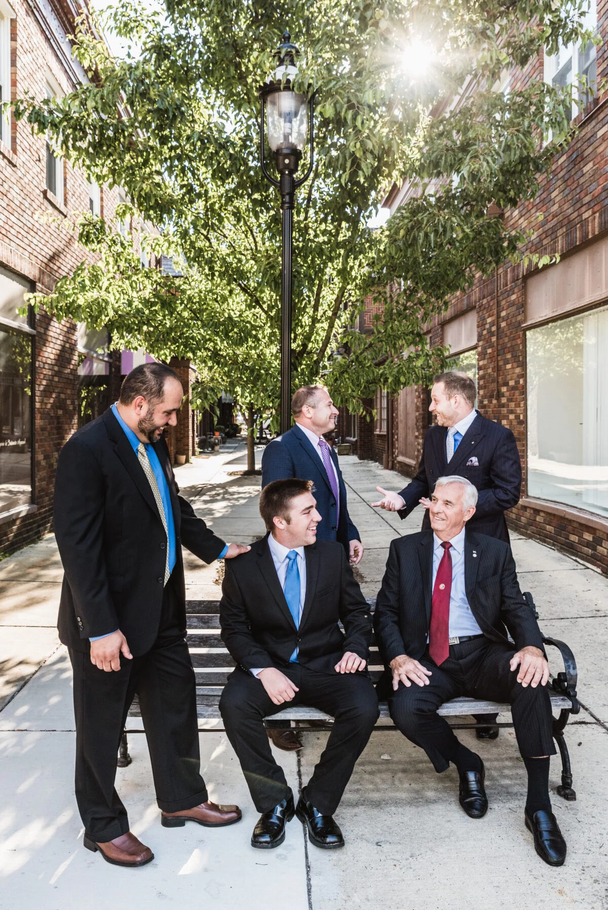 LF3_2449-1200×1797 Group of smiling men in suits talking together outdoors