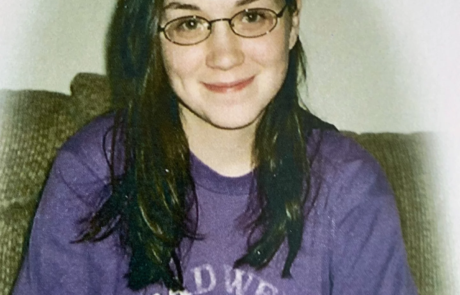 Young smiling girl sitting on couch.