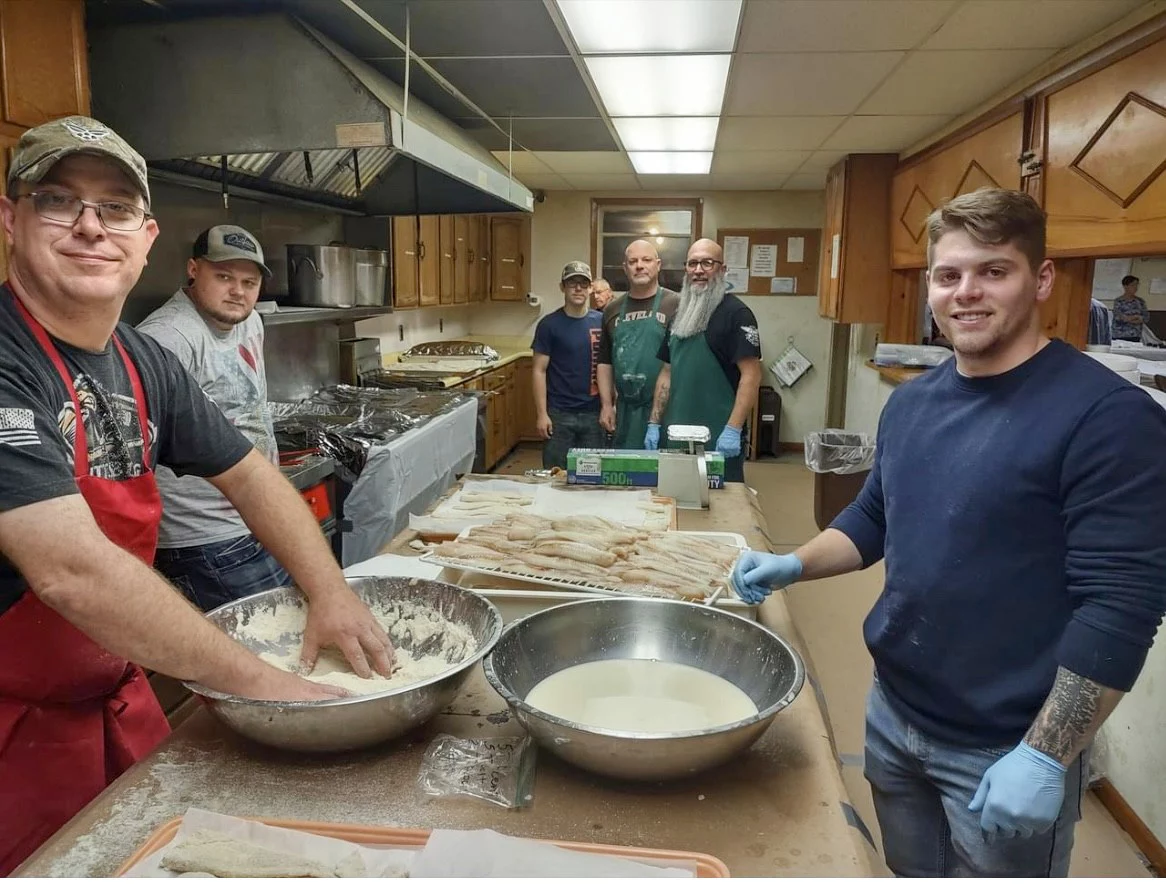 Group of Masons cooking in a kitchen together.