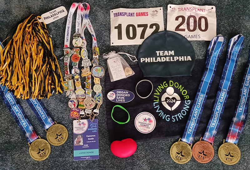 20240711_153435 Flat view of Team Philadelphia lanyards, metals, and other participation items.