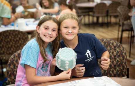 2V9A2076 Smiling girls showing off cake.
