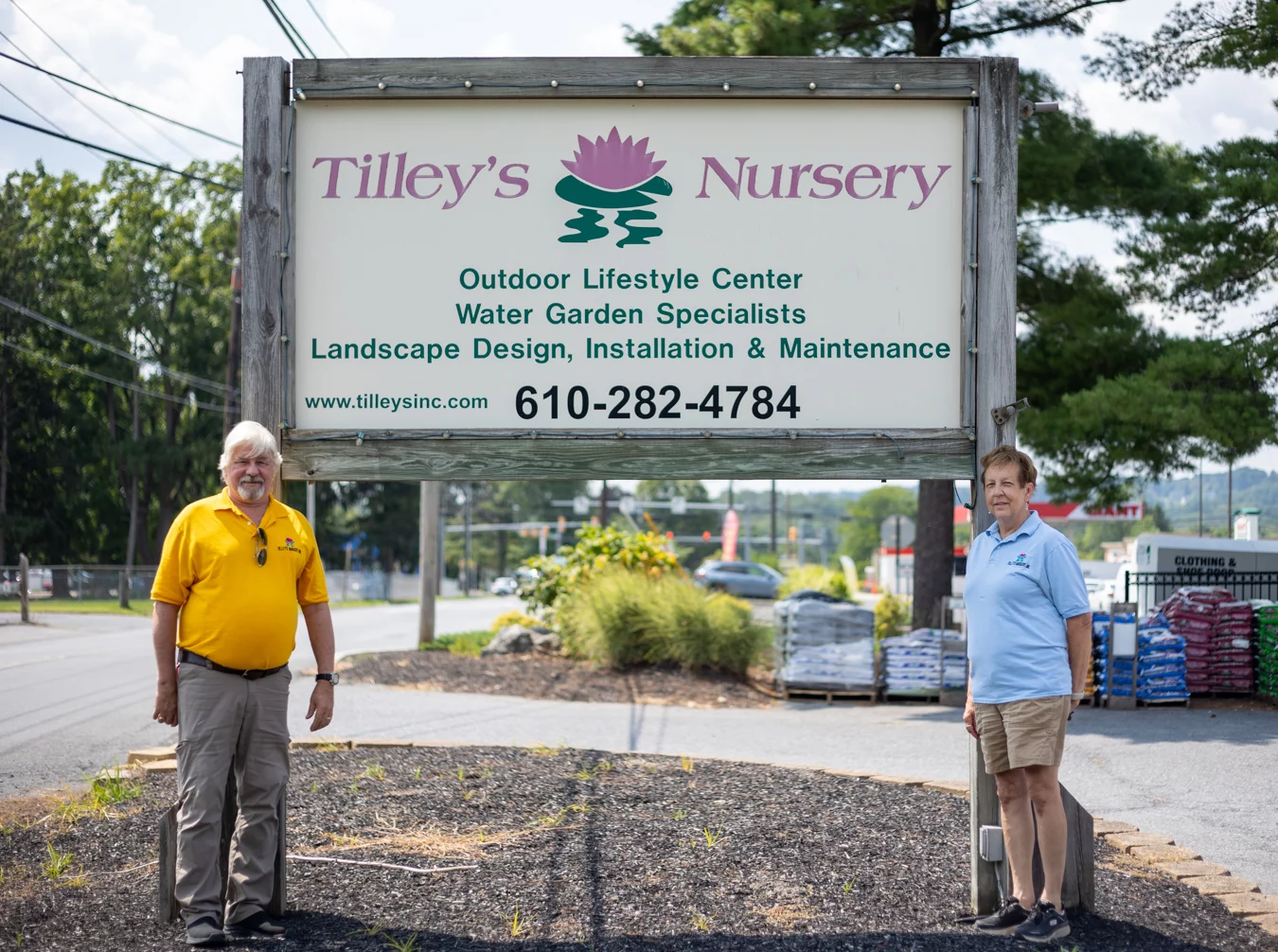 9I4A4062 Couple standing in front of nursery sign.