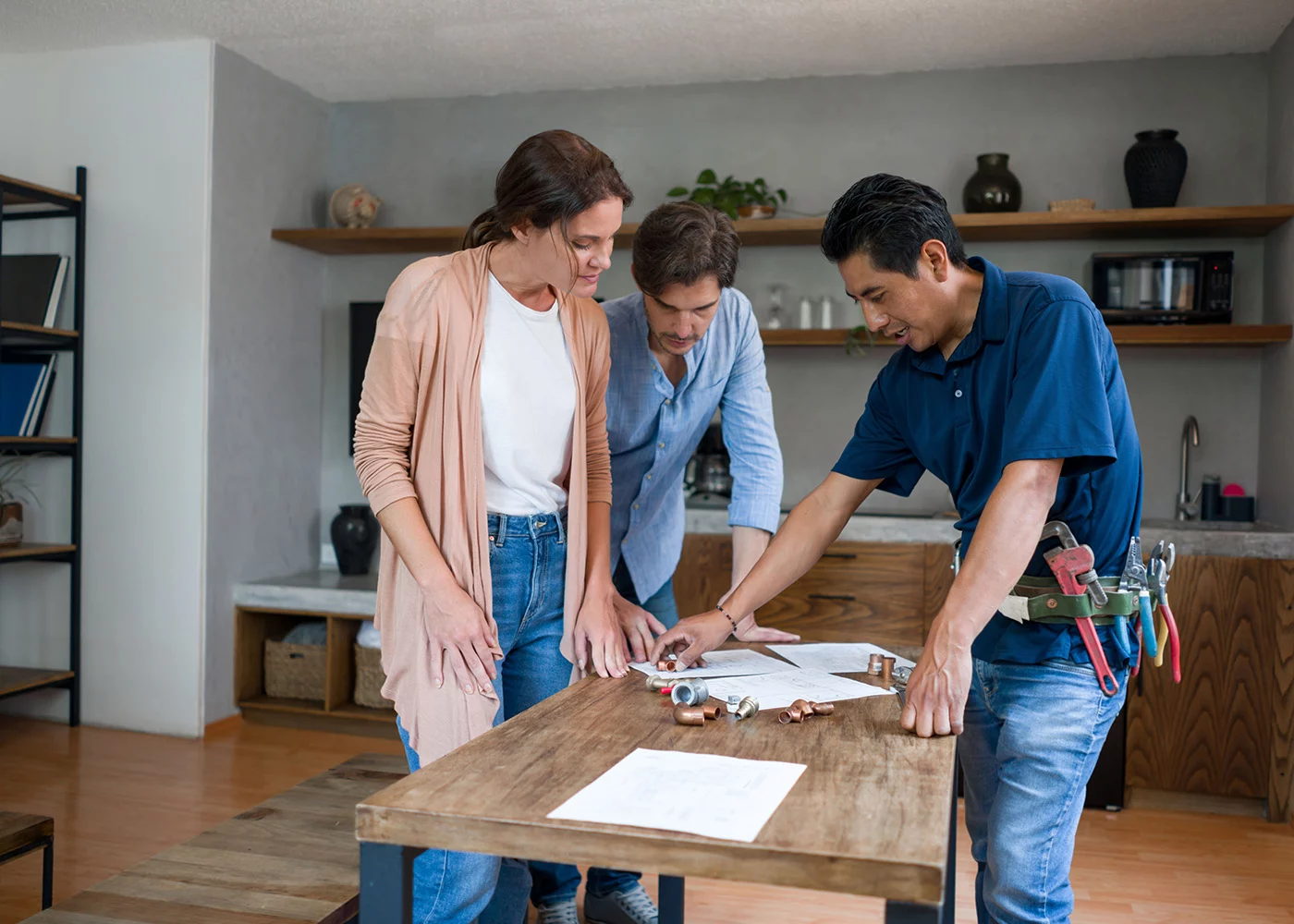 GettyImages-1345670548l Couple working with contractor in their home.