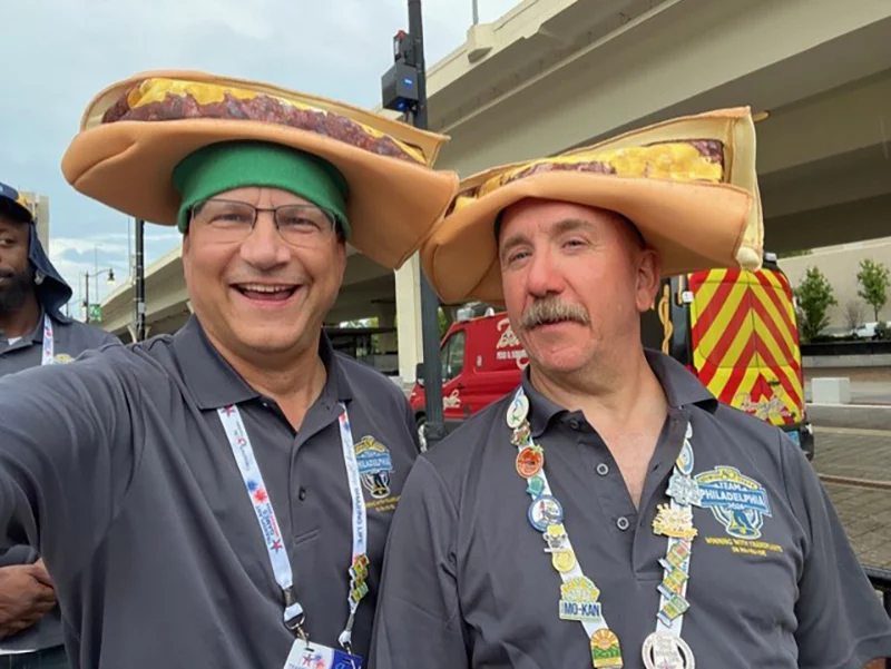 bill and cameron Two smiling men wearing cheesesteak hats while participating in the Transplant Olympics.
