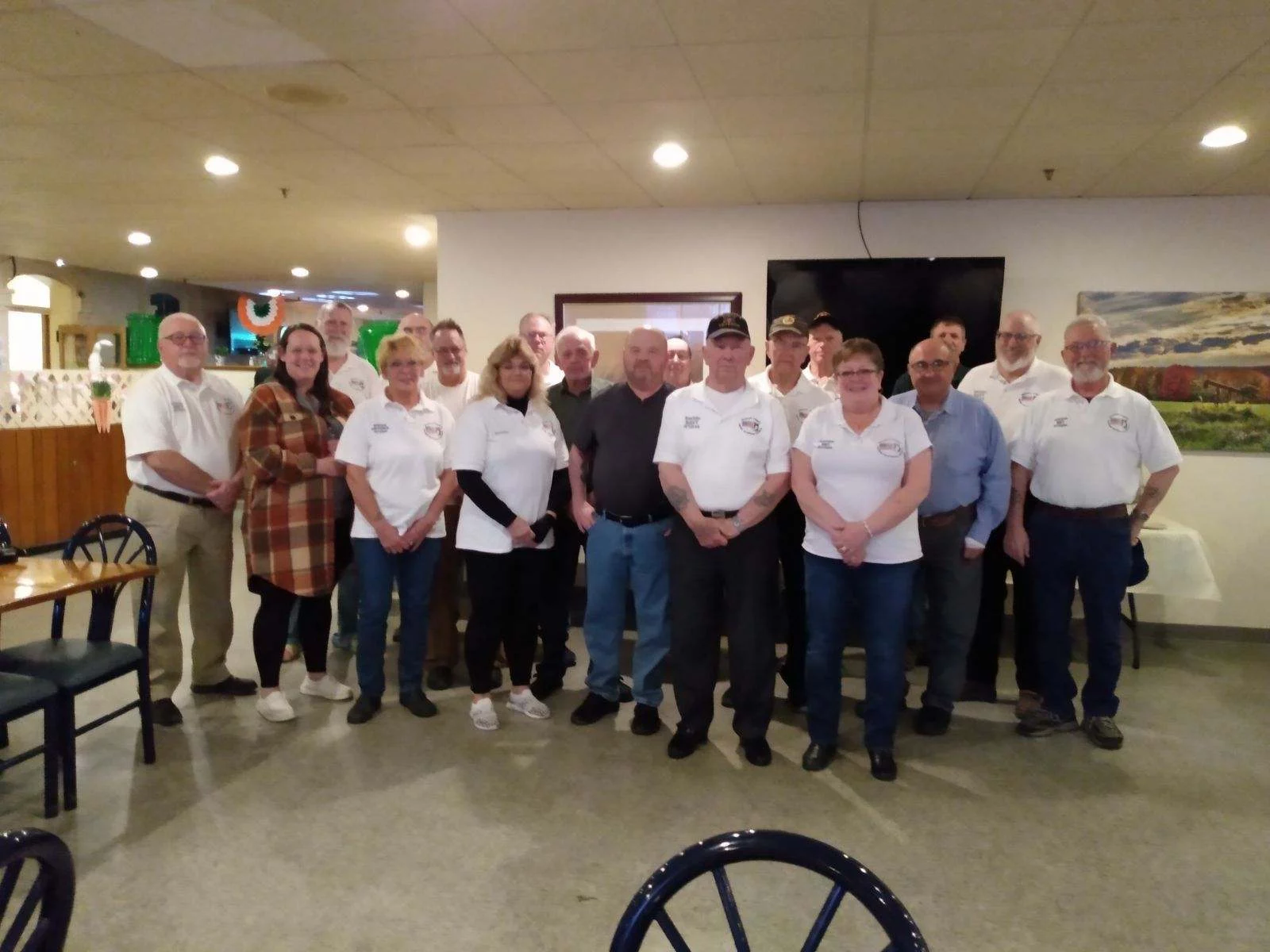 members of veterans council. we have a dinner every year thanking members for their work throughout the year Members of Veteran's council standing in large room.