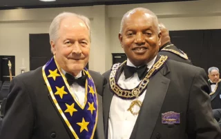 Two smiling men dressed in Masonic regalia.