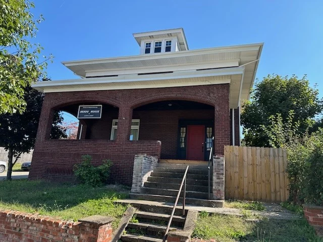 8 Brick home with stairs leading up to it.