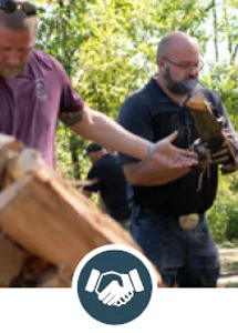 Closeup of men adding wood to a wood pile with icon of hands shaking.