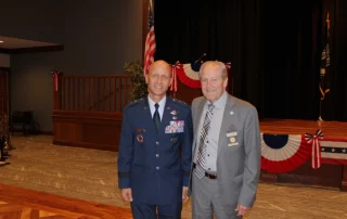 Mr. Larry Derr with man dressed in military regalia.