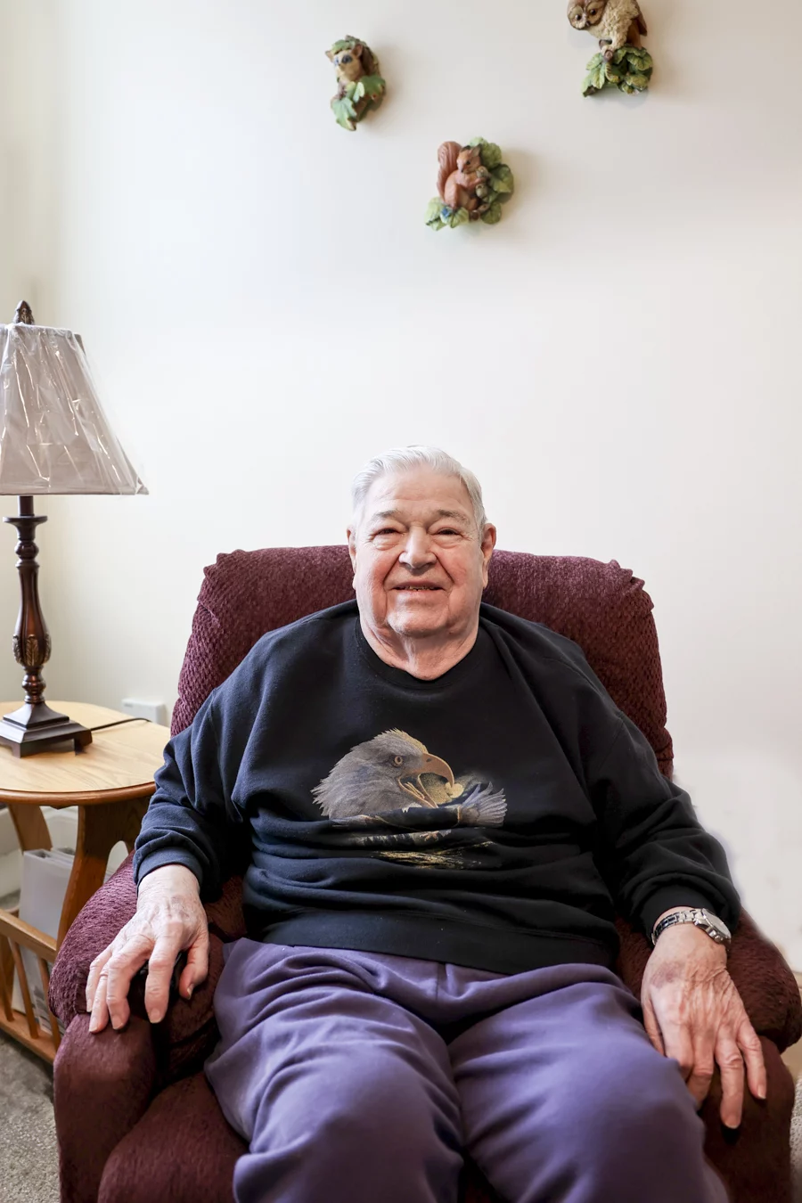 Smiling man sitting in chair at home.