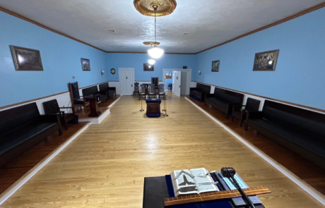42-2 Bright, open lodge meeting room with benches on either side.