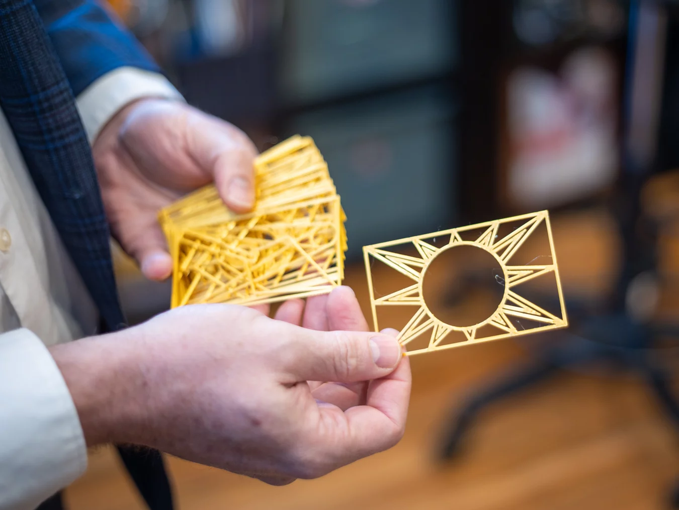 9I4A8132 Closeup of man's hands holding 3-D printed tarot deck.