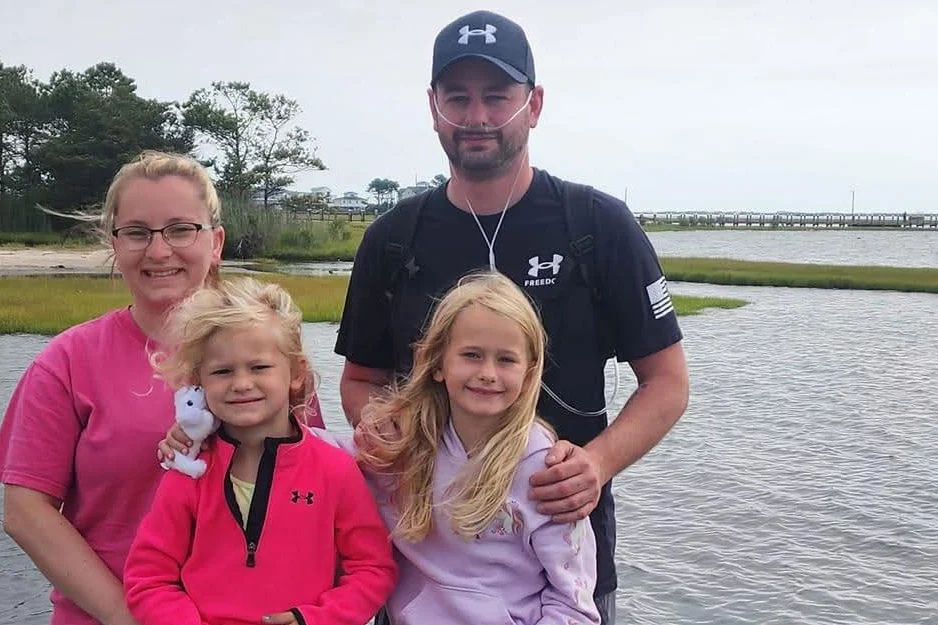 Smiling family outdoors.