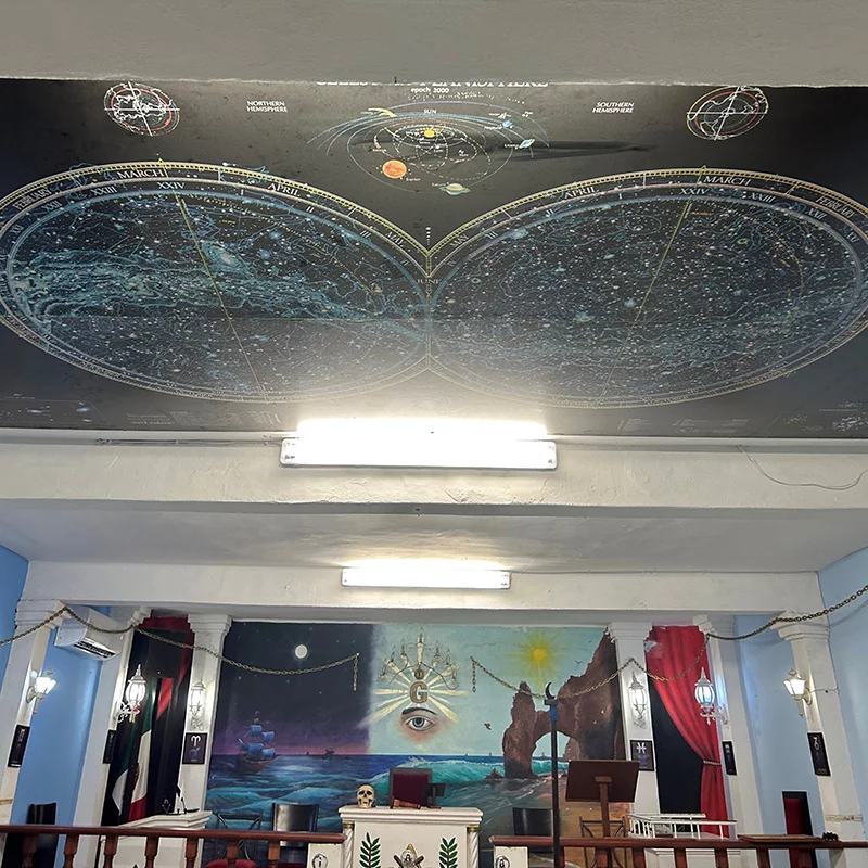 7 Ornate lodge room with murals on the ceiling and back wall.