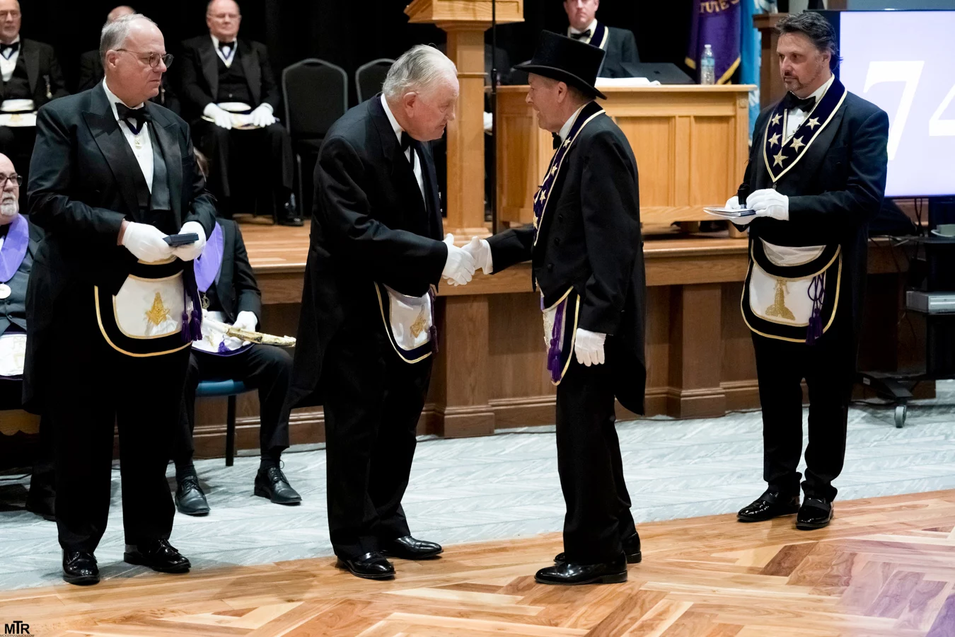DSC05990 Men in Masonic regalia shaking hands.