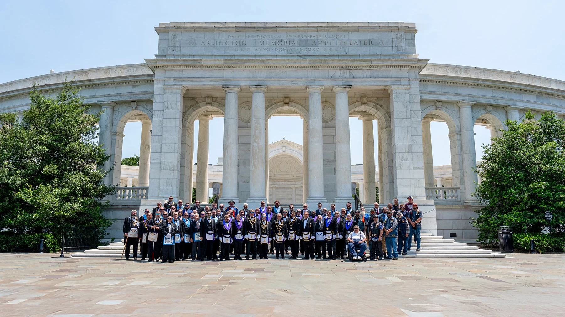Large group in masonic dress standing in front of Arlington Memorial Amphitheater.