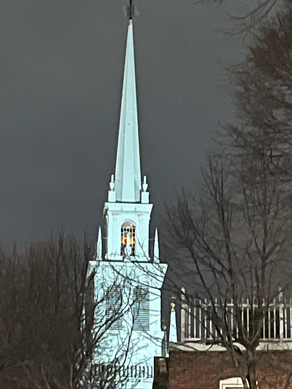 Illuminated historic church spire in Boston.