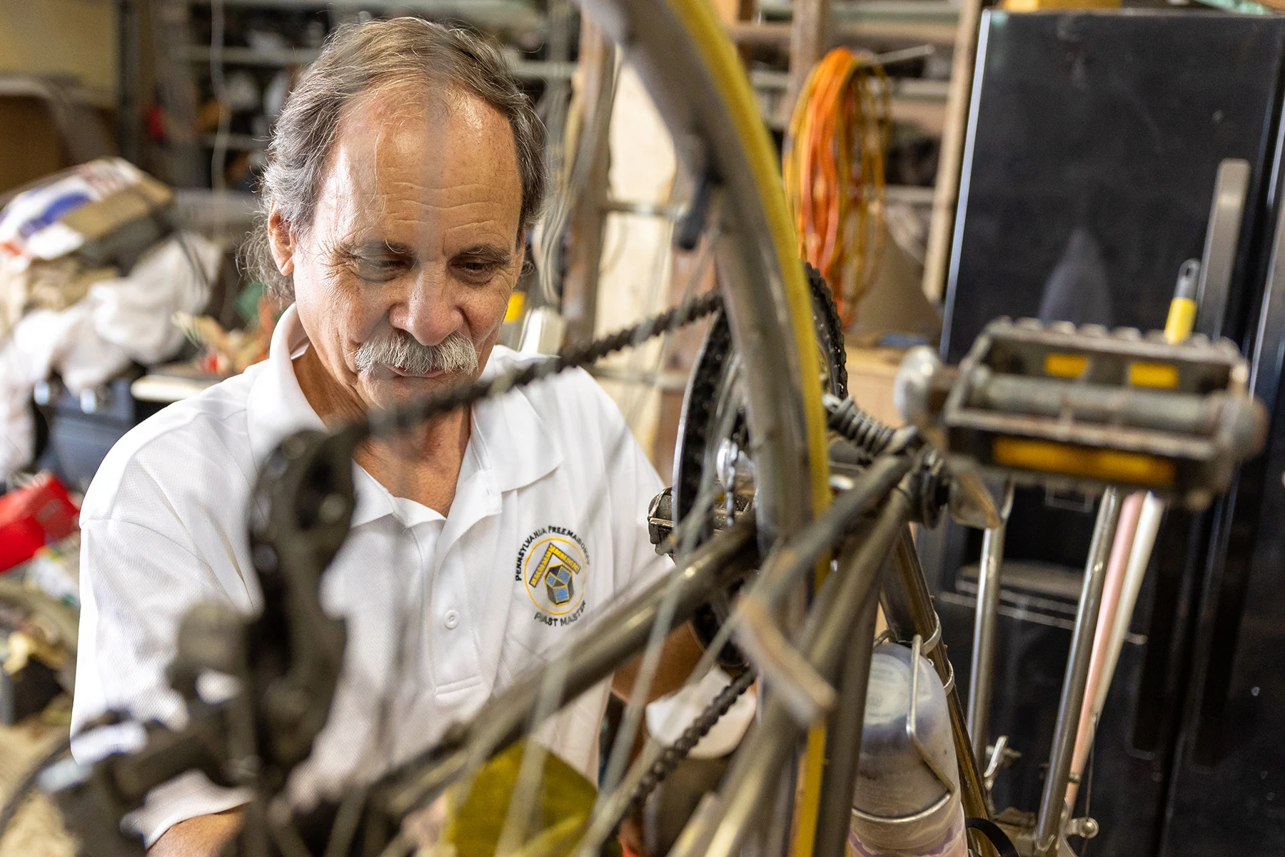 Man working on his bicycle while it's upside down.