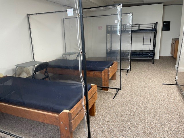 Beds lined up indoors with dividers