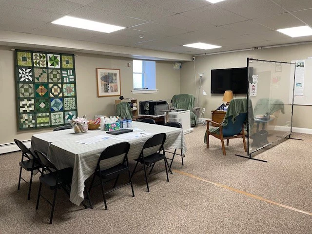 Table and chairs setup in large room with tv.