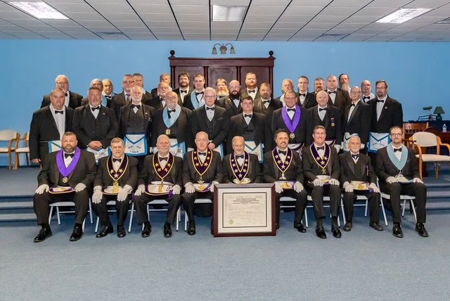 Spartan1 Group of men in Masonic Dress sitting in lodge room.