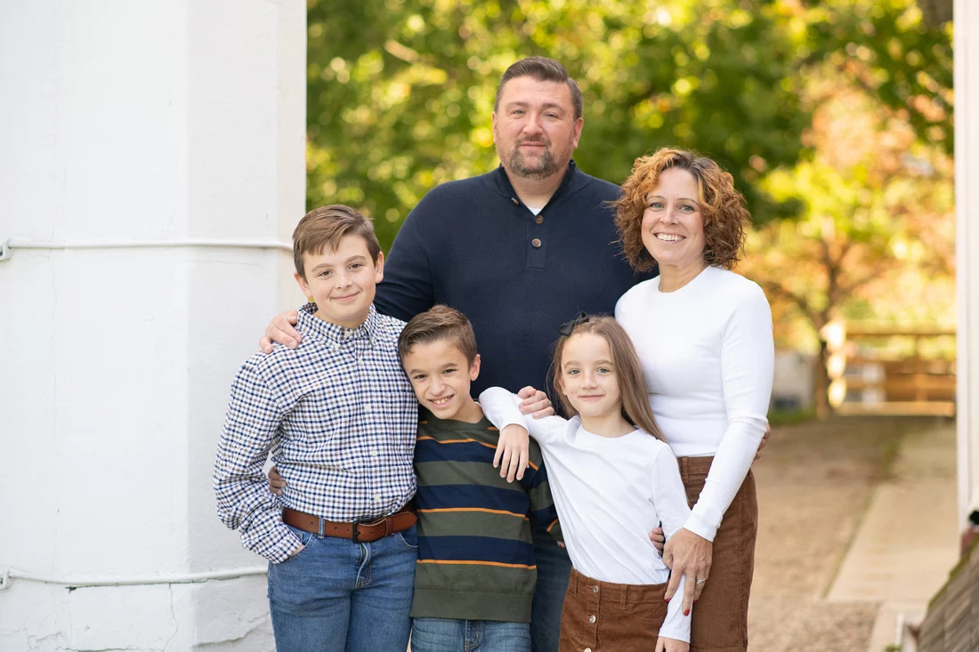 Untitled-15 Family portrait of couple and three children standing outdoors.
