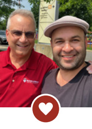 Two smiling men with heart icon