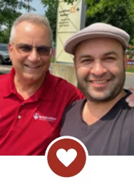 Two smiling men with heart icon