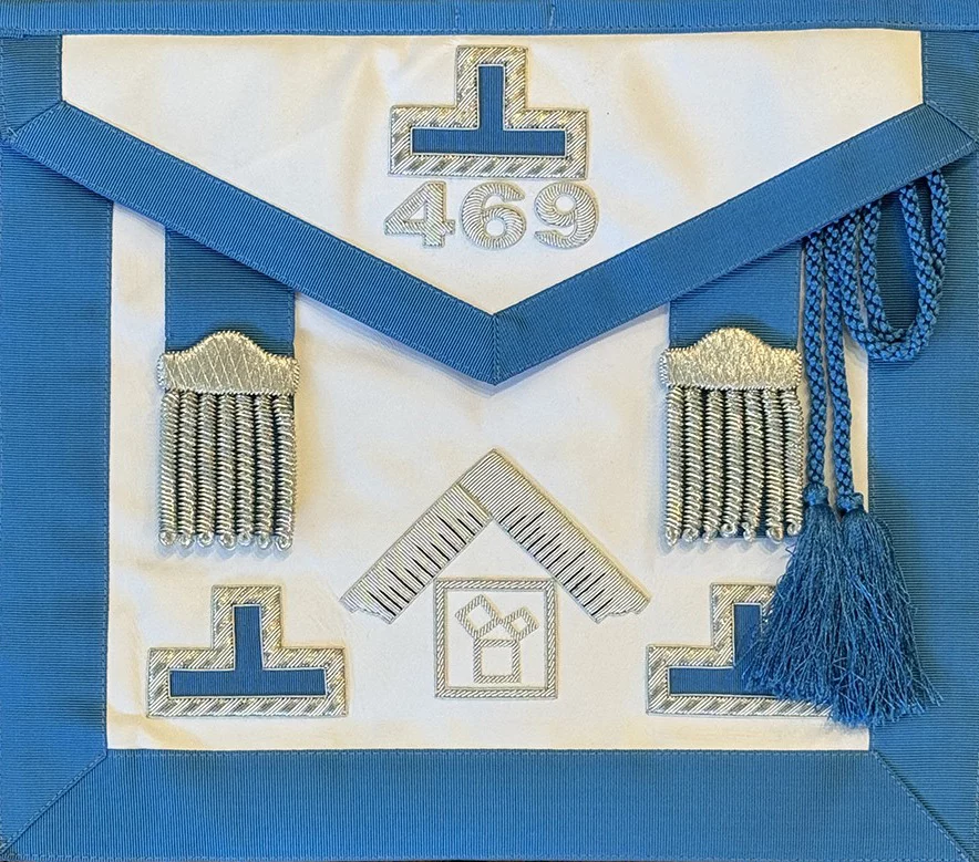 Closeup of Masonic apron with embroidered designs.