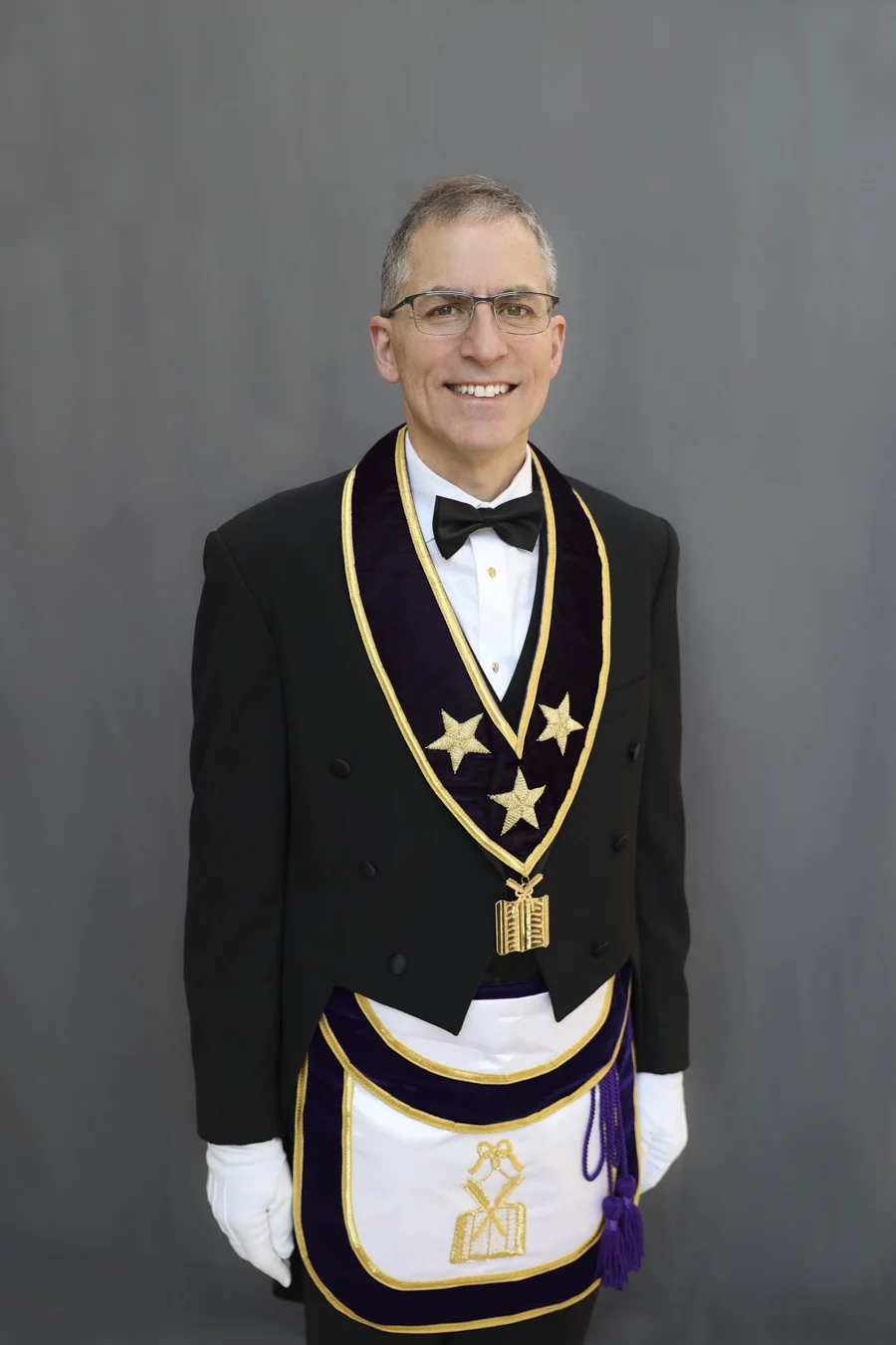 1W8A0411-Edit Smiling man with short hair and glasses dressed in Masonic Grand Lodge Officer attire.