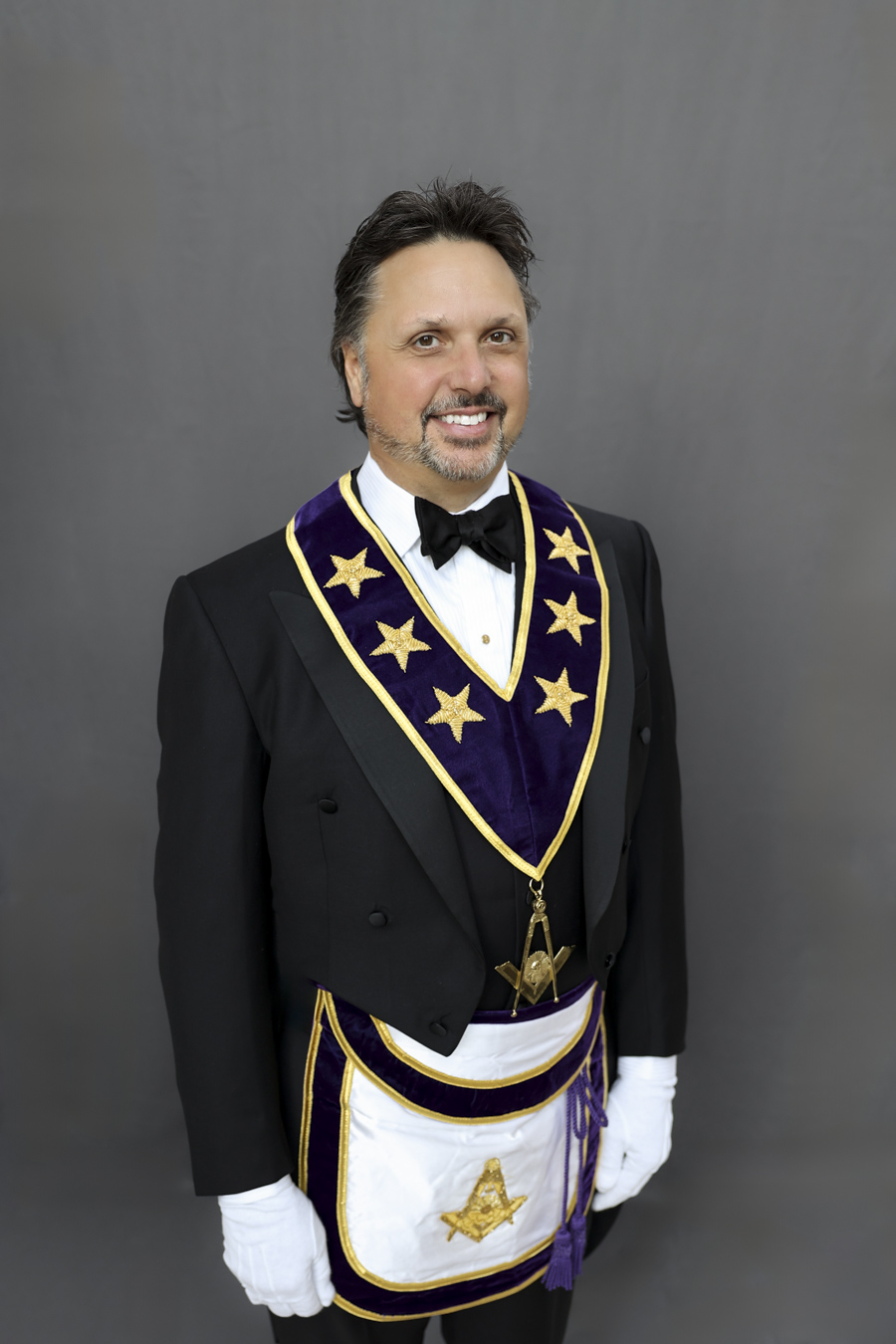 Man with short dark hair and beard dressed in Masonic Grand Lodge Officer attire.
