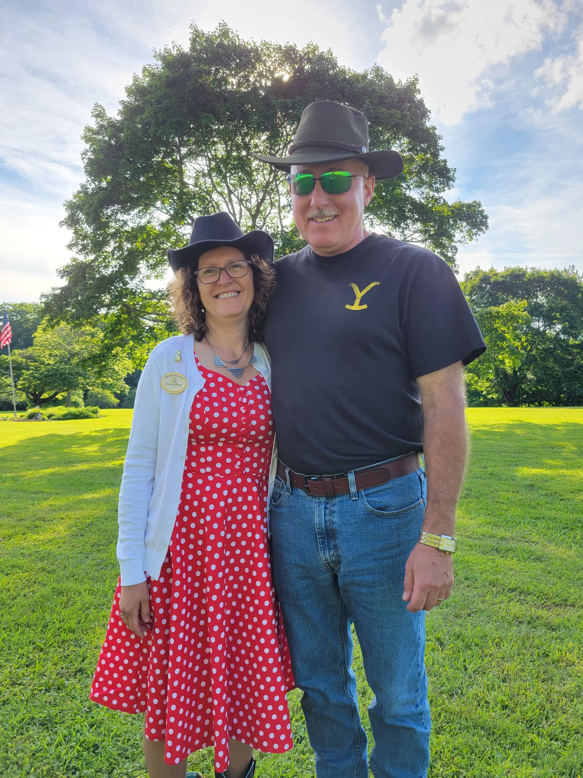 Grand Master Robert Brink and his wife in cowboy hats outdoors.