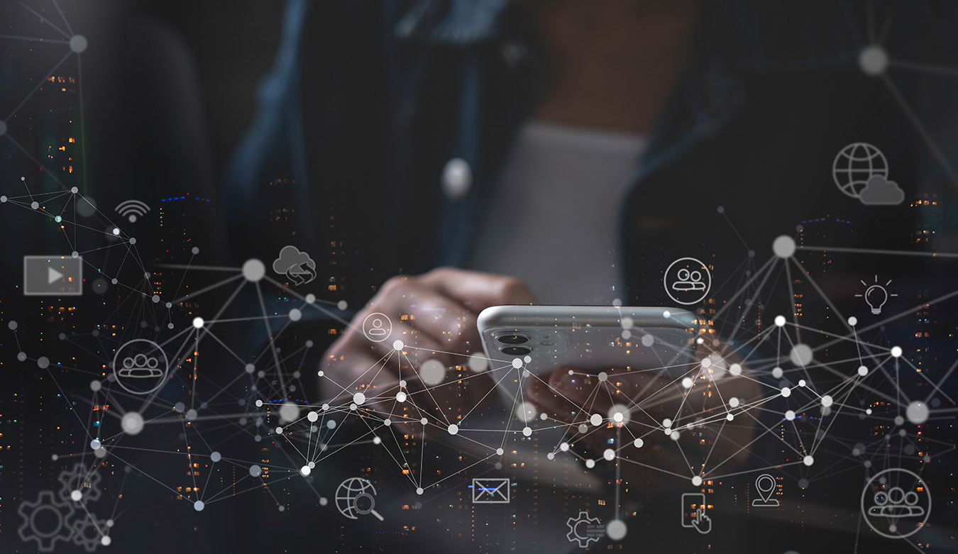 Technology concept with person typing on their phone with icons in the foreground.