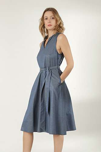 Woman in grey, knee-length dress.