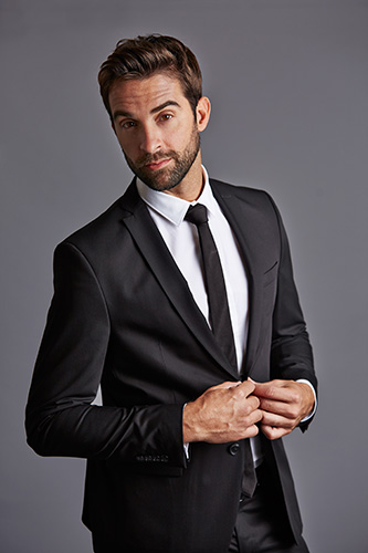 Man in suit, collared shirt and tie.