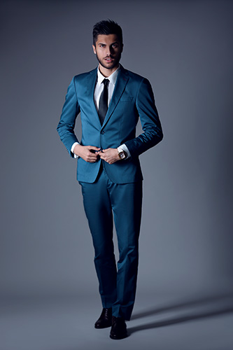 Man dressed in dark suit and tie.