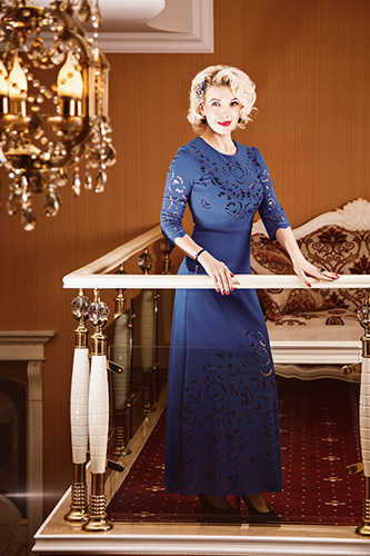 Woman in full-length navy blue dress.