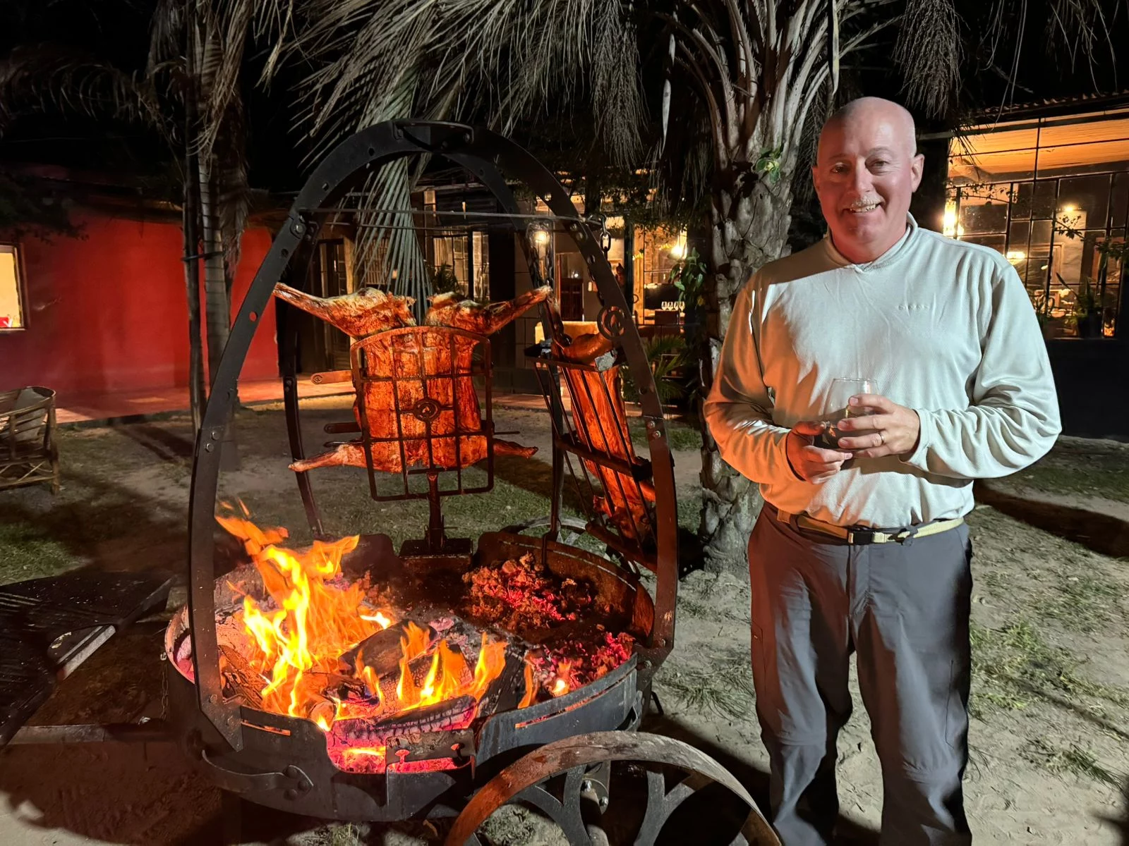 Grand Master Robert Brink cooking food on top of open firepit.