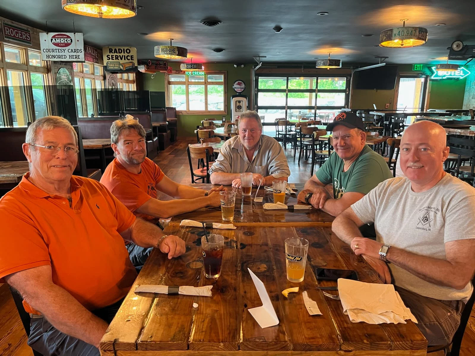 Group of men sitting at a table in a restaurant.