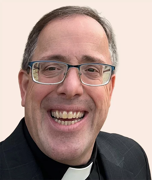 Smiling man with short hair and glasses.