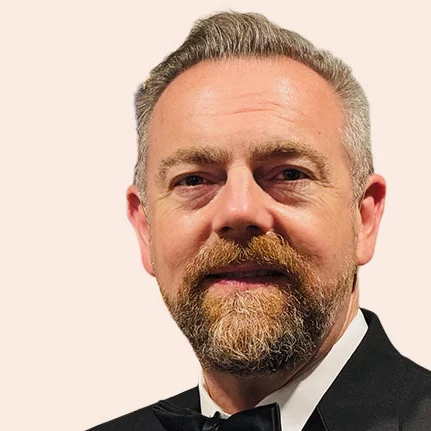 Headshot of man with short hair and beard.