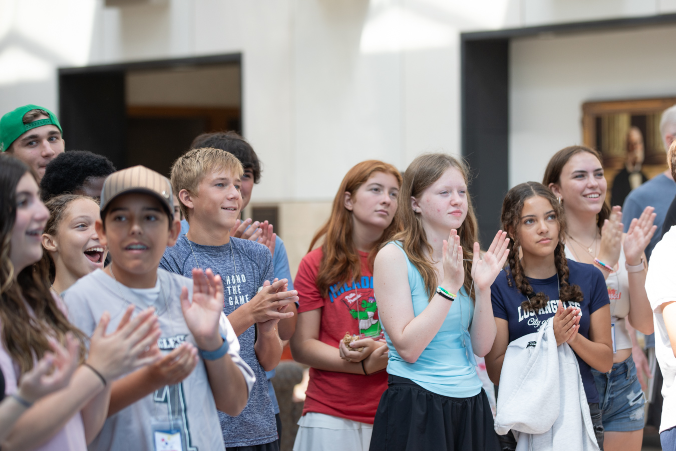 Group of children smiling and clapping.