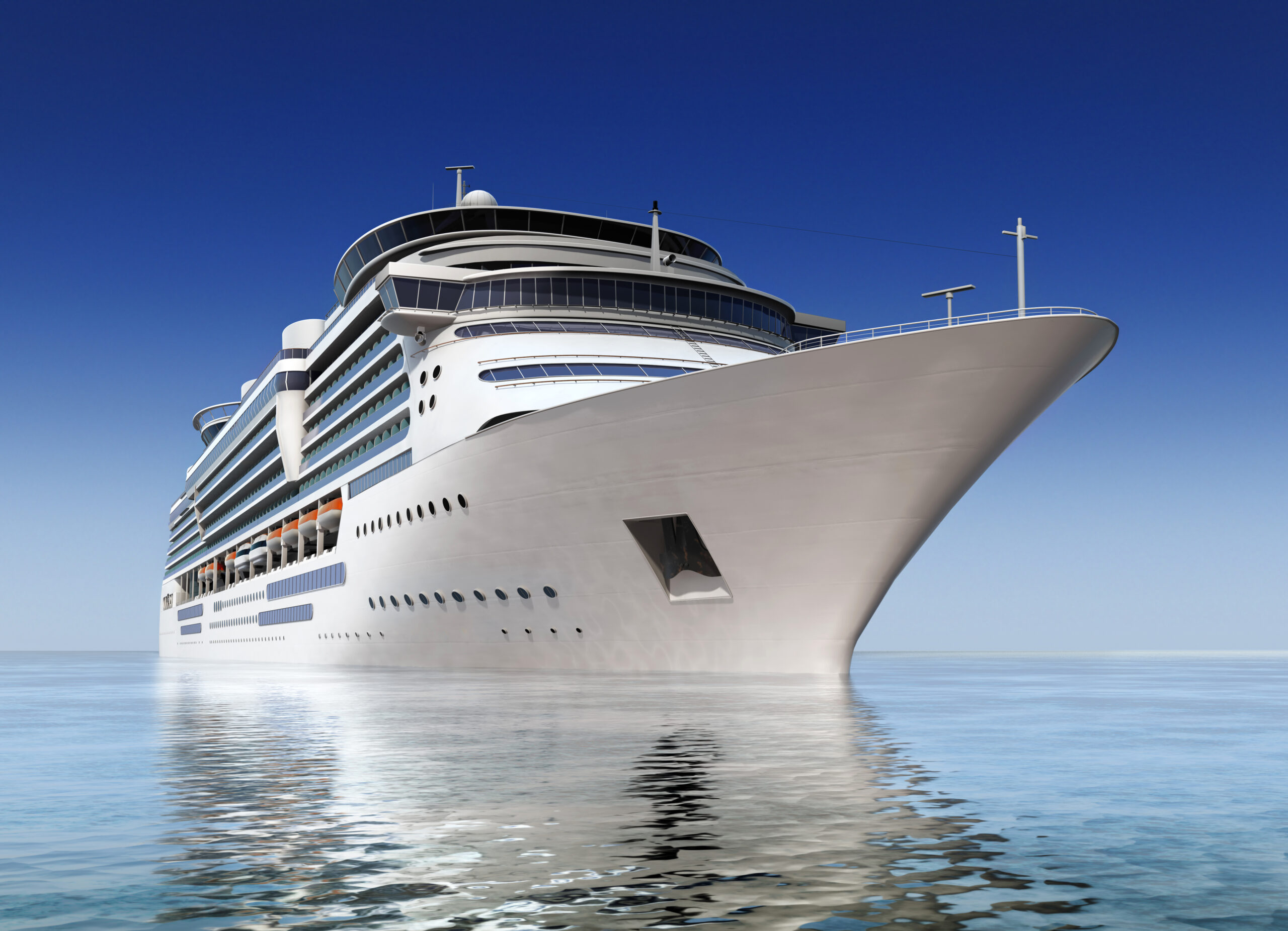 Large, white cruise ship with a clear blue sky behind it.