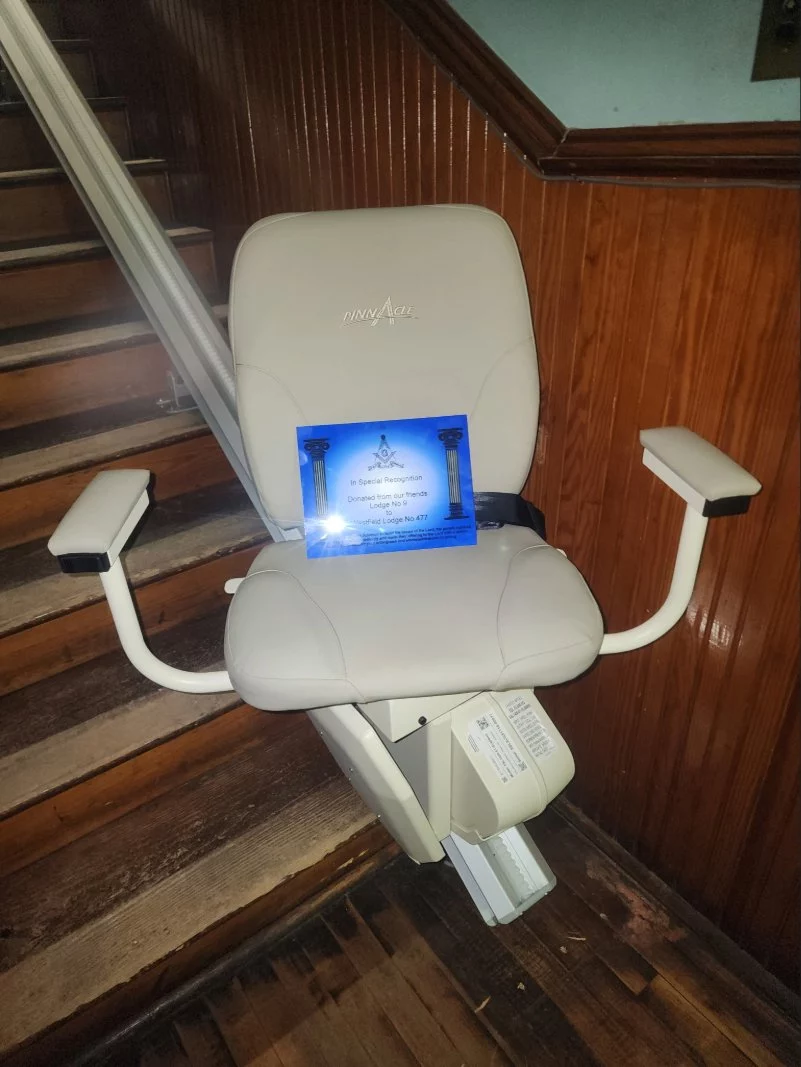 chair image – photo credit Bro. Kirk Payne Accessible chair on a rail on a stairwell.