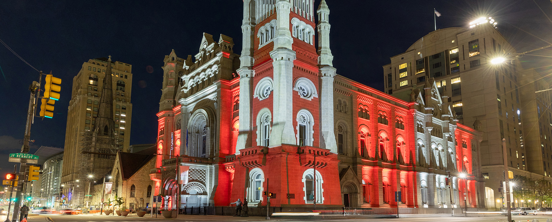 Landscape view of the Masonic Temple with red and white lighting illuminating the building.