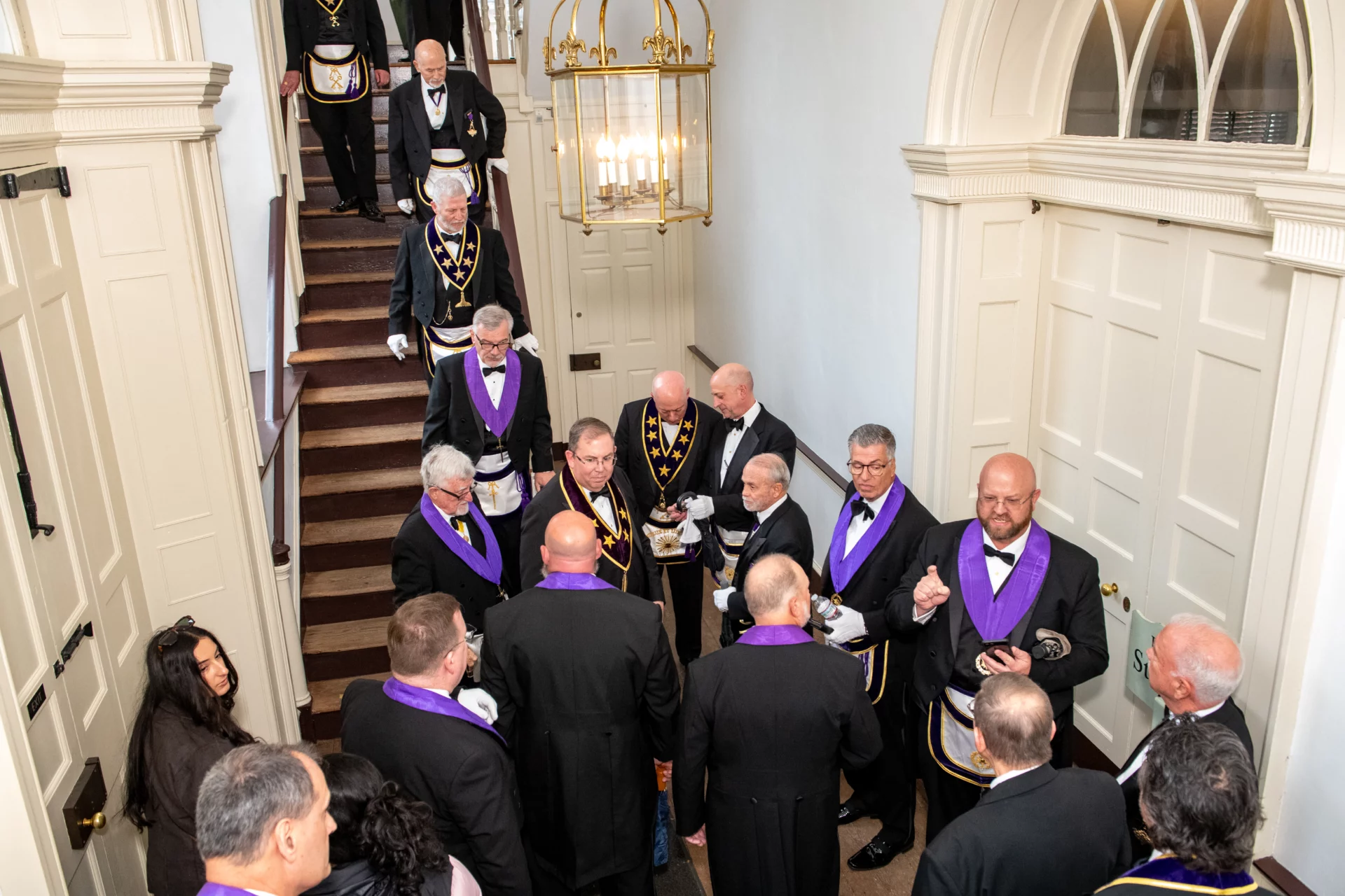 Smiling group of Masons gathered in a stairwell.